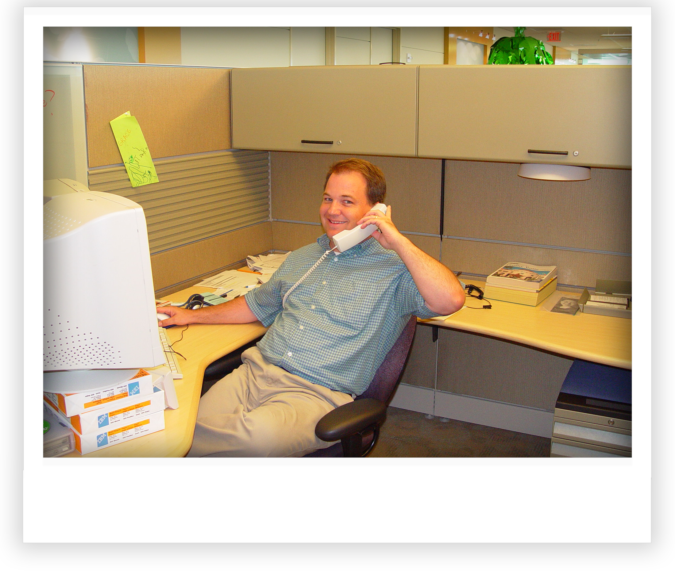 Joe Pickerill explaining log file data to an IBM  Tivoli product manager while somehow balancing the world’s largest CRT monitors on stacks of hijacked printer paper.