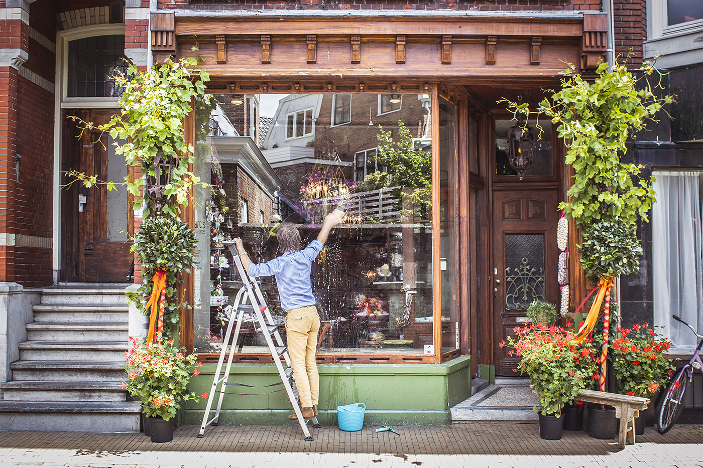 Owner watering plants in window