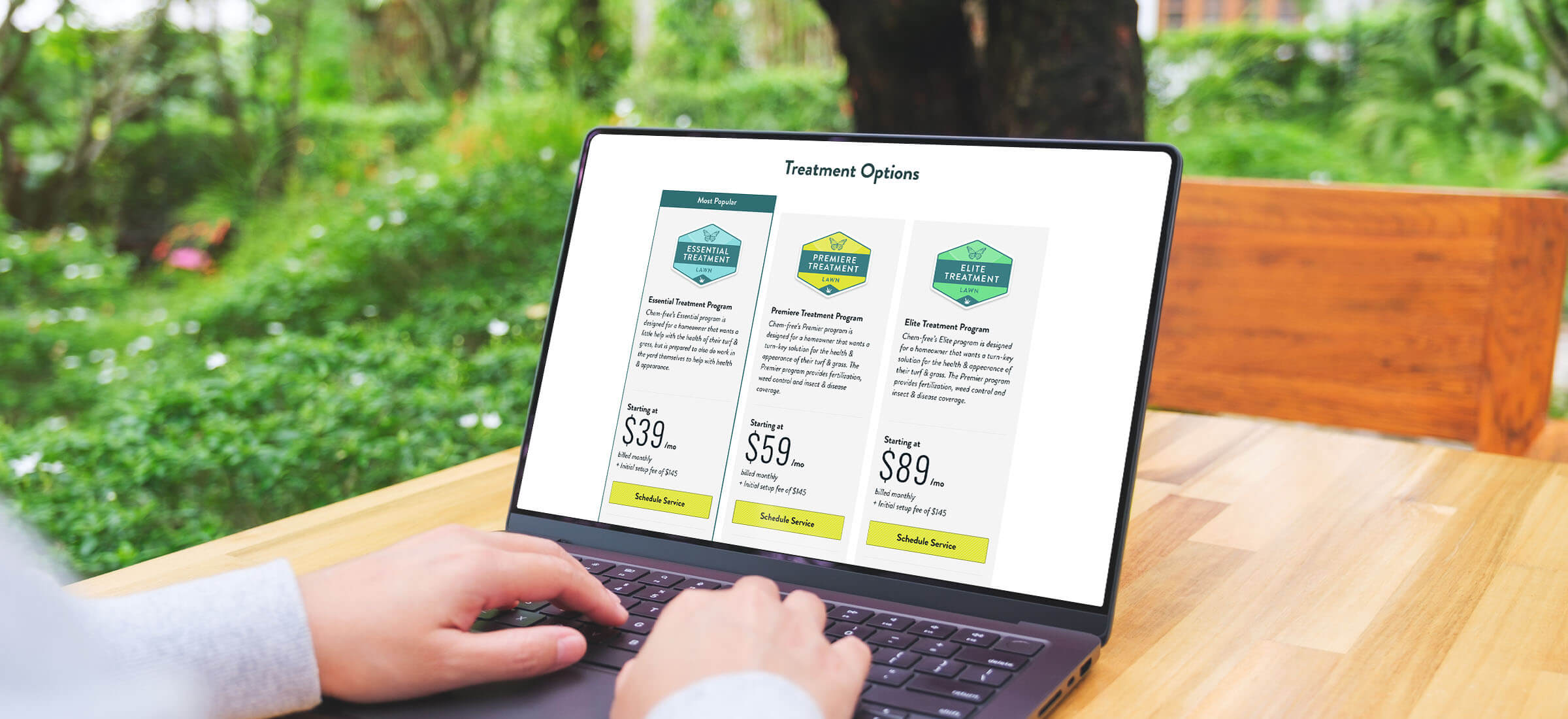A laptop sitting on a patio table displaying the Chem-free pricing tables