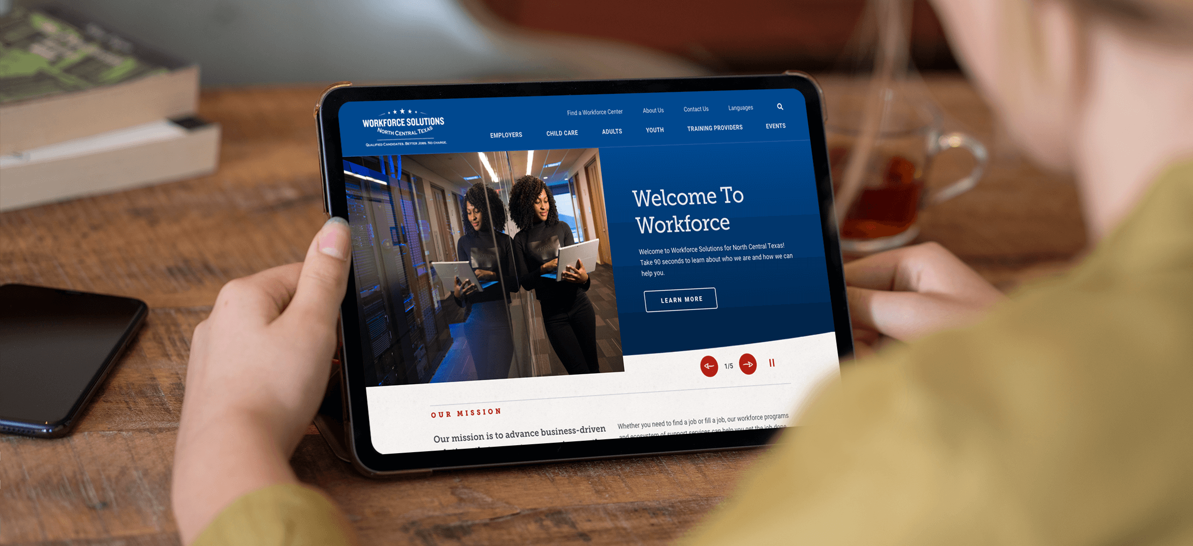 person holding an ipad displaying home page
