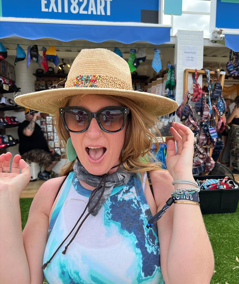 Selfie of Adrienne trying on a hat.