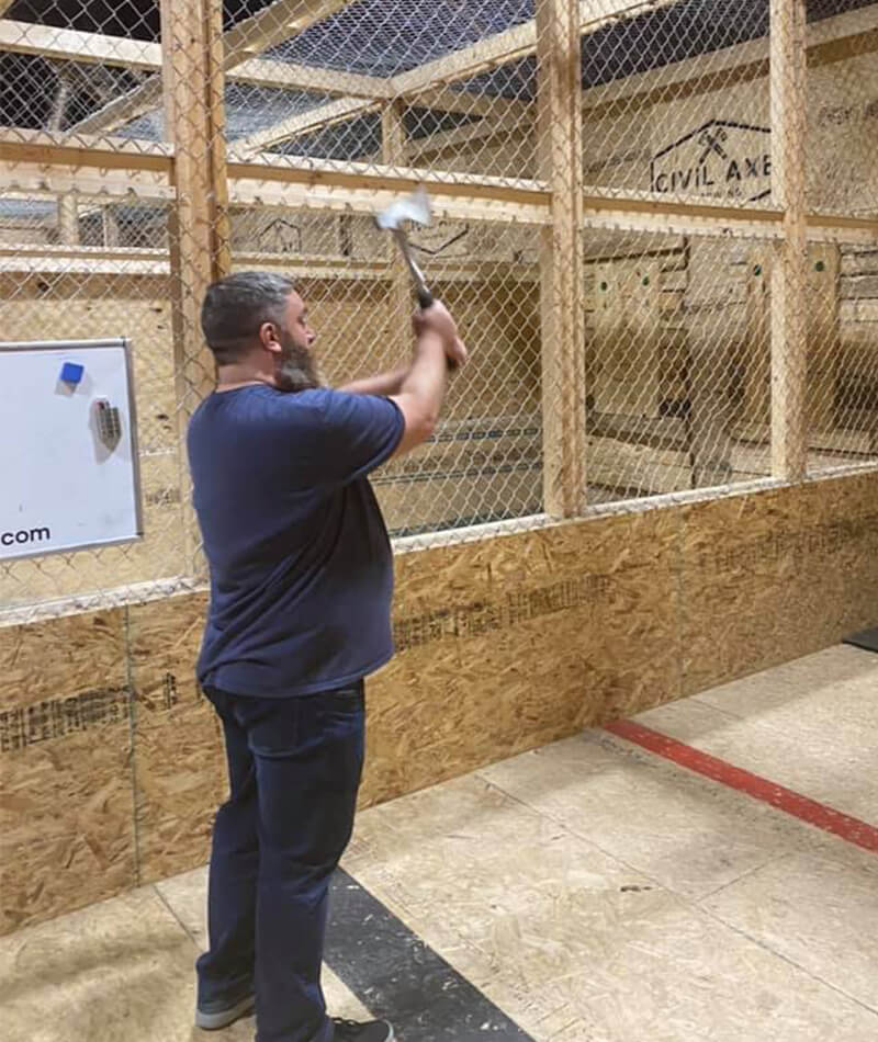 John lining up his shot at a local axe throwing club, Civil Axe.