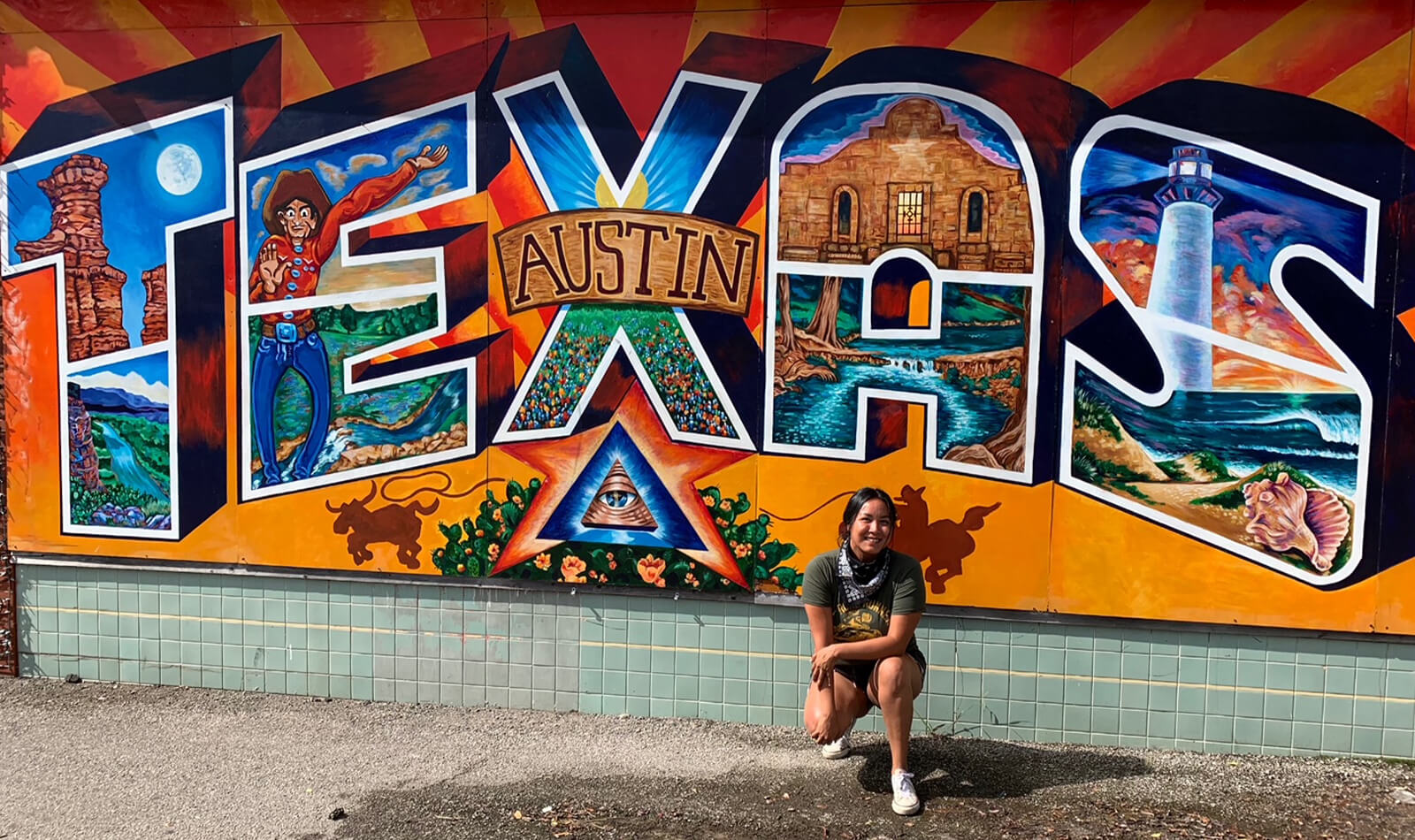 Julia posing in front of a painted mural in Austin, Texas.
