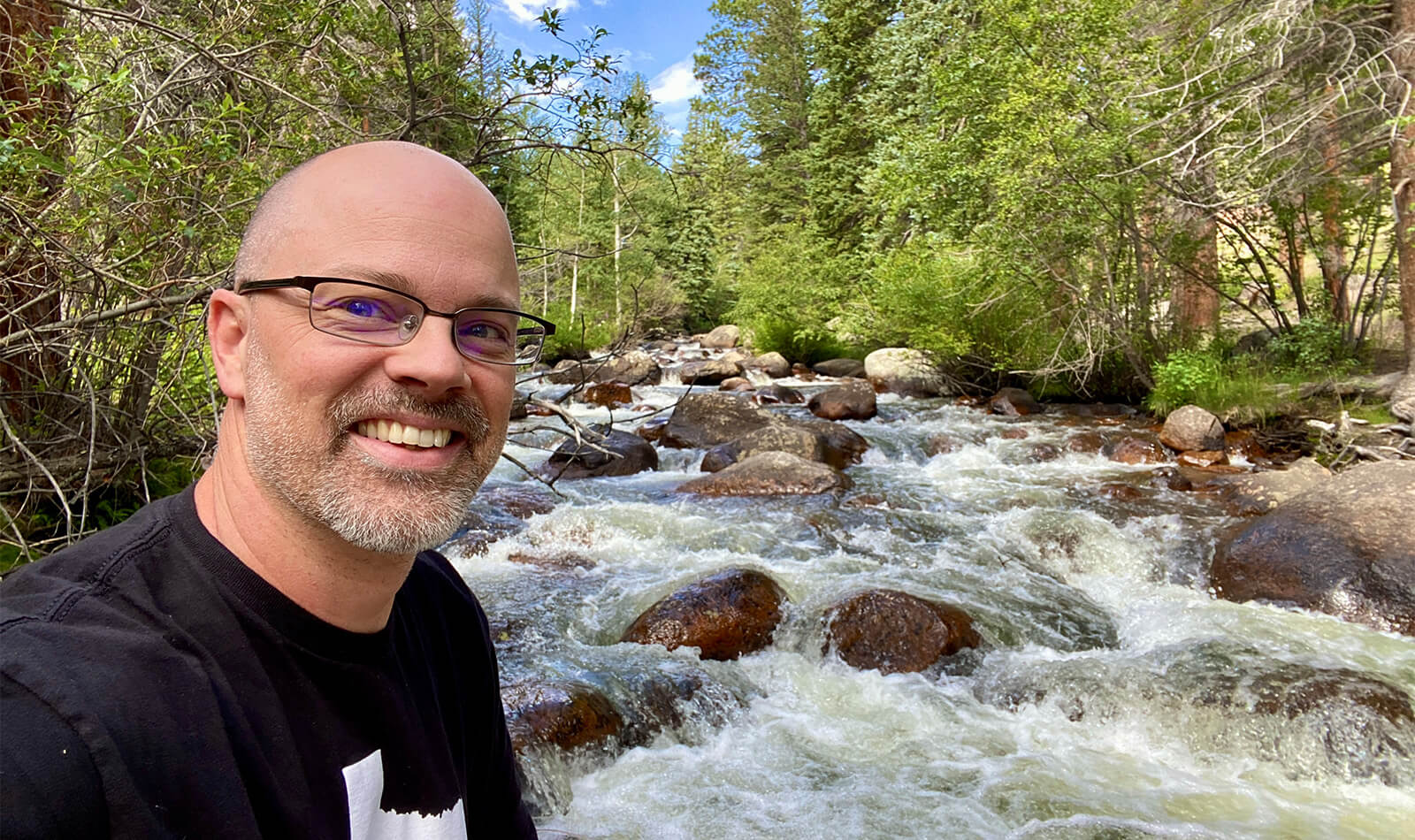 Selfie of Nathan at a river.